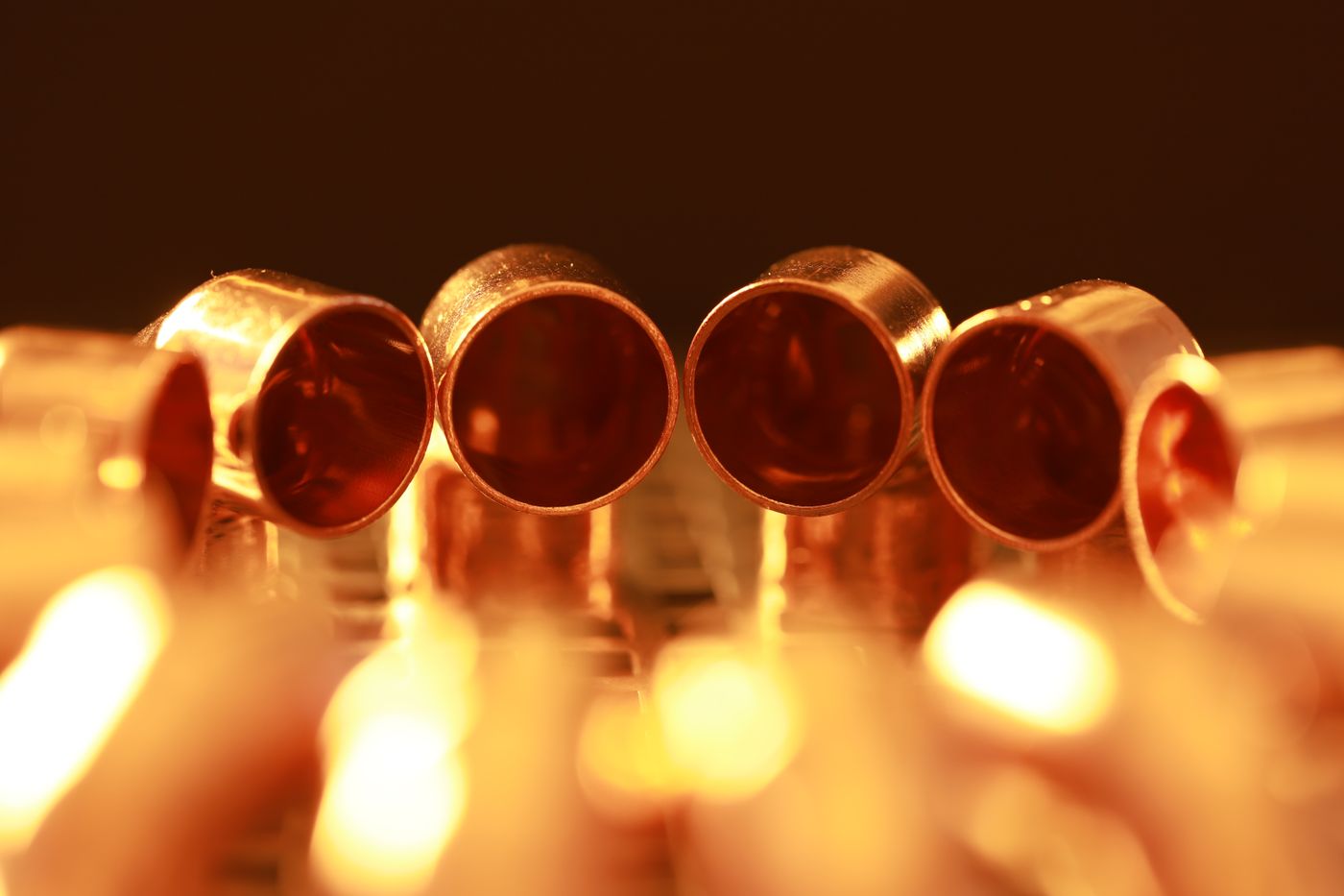 Close-up of cut copper pipe ends and couplings used in plumbing repipe work