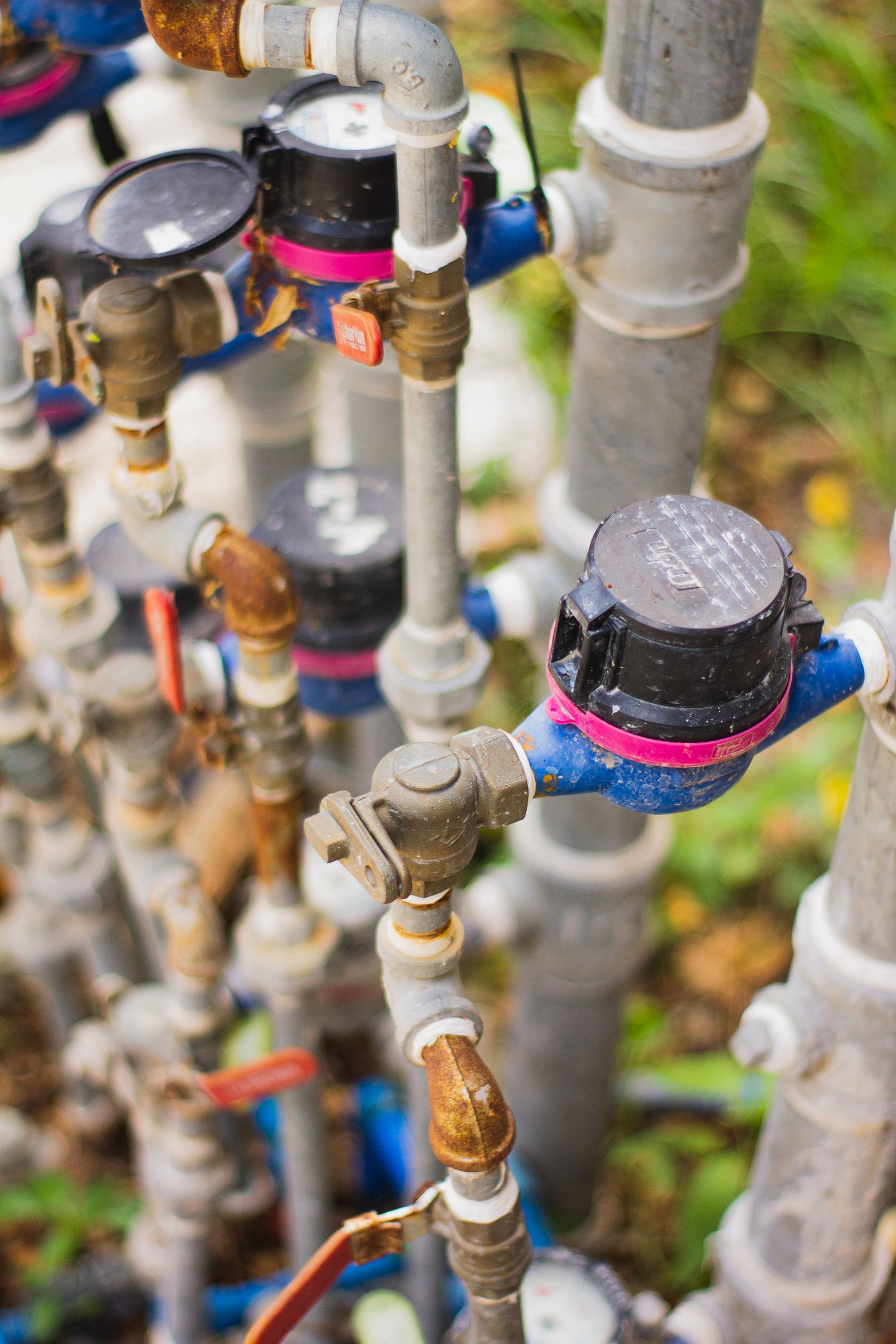 A bank of residential water meters and shutoff valves